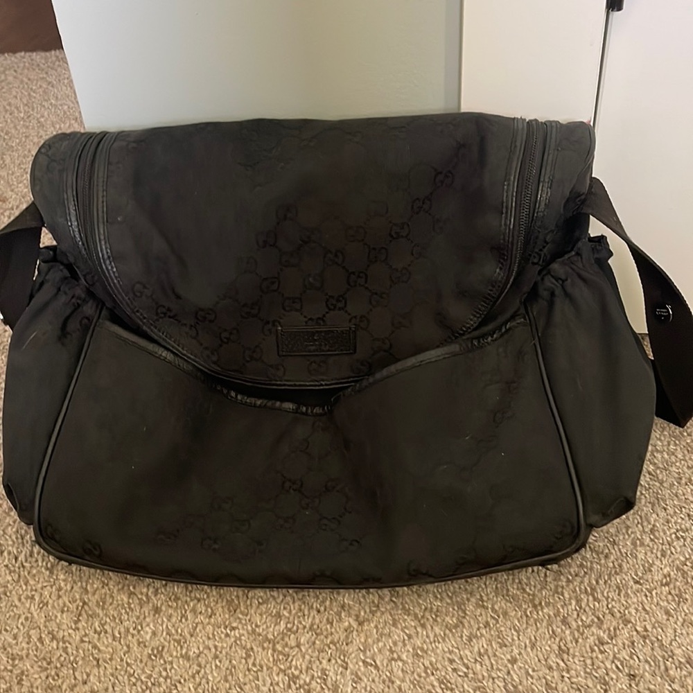 This is a Gucci bag it has a lot of space and has been used once